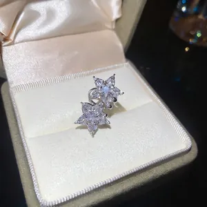 Elegant silver star ear clips with sparkling cubic zirconia on a beige velvet jewelry box
