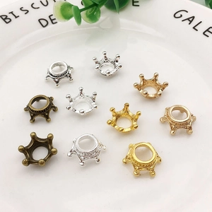 Mix of gold, silver, and bronze crown-shaped alloy charms for DIY jewelry making