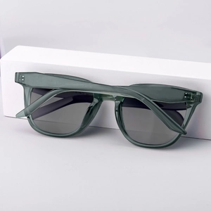 Modern cat-eye polarized sunglasses in transparent grey on white geometric blocks