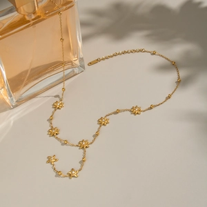 Elegant gold flower necklace with crystal accents and Y-shaped chain for women