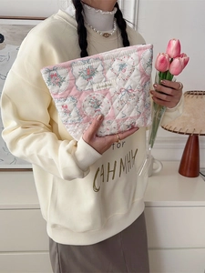 Quilted floral makeup bag with blue bows and soft cotton texture for daily storage