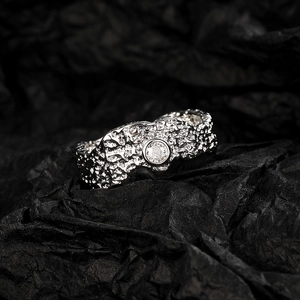 Irregular textured vintage silver open ring featuring a round clear gemstone centerpiece