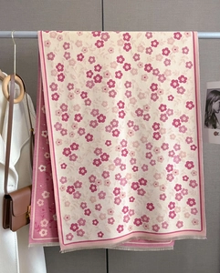 Detail of pink floral double-sided scarf with elegant tassels hanging as lifestyle decor