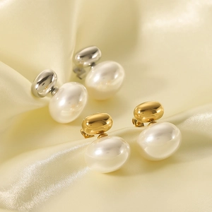 French geometric pearl earrings in gold and silver finish on soft silk fabric