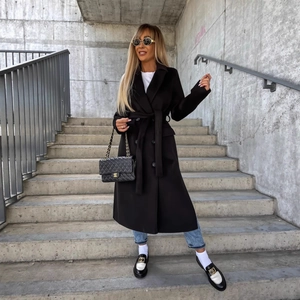 Classic black wool overcoat with lapel collar and waist belt styled for fall fashion
