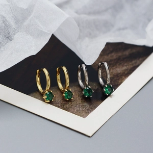 Close-up of S925 sterling silver hoop earrings with green zircon in gold and silver finish