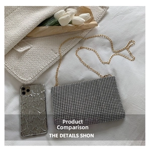 Detail of silver rhinestone evening bag with gold chain strap and metallic phone case