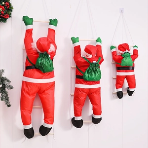 Three climbing Santa Claus dolls in different sizes on a rope ladder with wooden rungs
