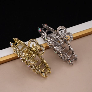 Detailed view of hollow vintage flower hair claws with rhinestones in gold and silver