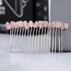 Macro shot of pink crystal stones hand-wrapped on a silver metal hair comb detail