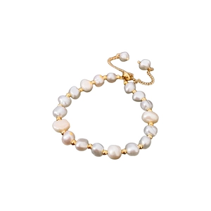 Elegant adjustable pearl bracelet featuring white pearls and gold beads on white background