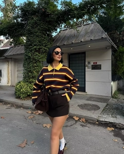 Detail showing vintage striped polo knit top with dark brown mini skirt and suede bag