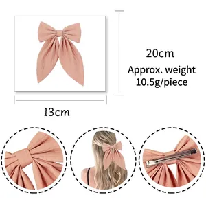 Pink ribbon bow hair clip in textured fabric with metal alligator clip and 20cm length