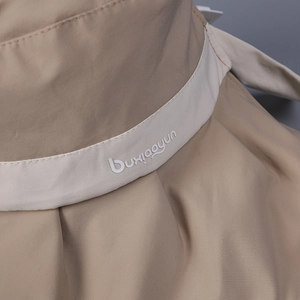 Detailed close-up of khaki sun hat fabric texture with premium stitching and logo strap