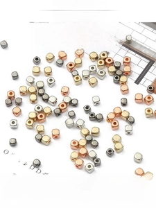 Macro shot of square CCB spacer beads in gold, silver, and rose gold for DIY jewelry