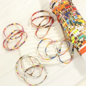 Macro shot of colorful Tila enamel beaded bracelets with flexible elastic band weaving