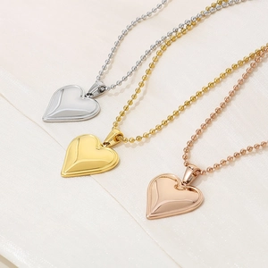 Minimalist heart pendant necklaces in silver, gold, and rose gold with ball chains