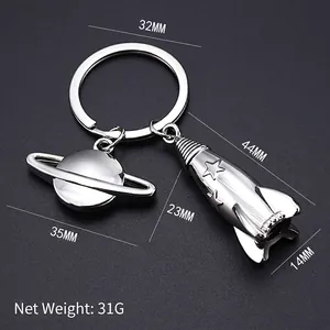 Silver metal rocket and Saturn planet keychain with detailed size measurements