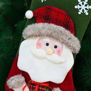 3D Santa Claus Christmas stocking with red plaid and faux fur trim on a pine branch