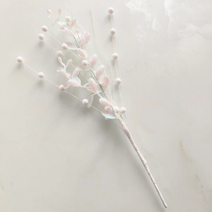 Close-up of sparkling white glitter berry branches for DIY Christmas home decoration