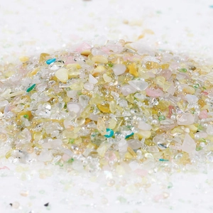 Detailed close-up of 2-8mm colorful crushed glass stones and tiny pearls for DIY crafts