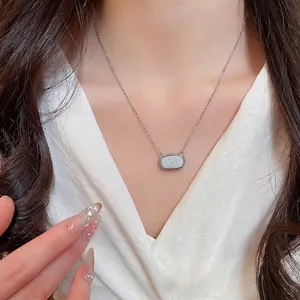 Minimalist silver chain necklace with a shimmering rectangular resin pendant for women