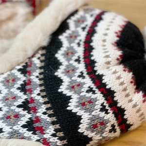Close-up of Fair Isle knit pattern and soft faux fur lining on a winter earflap hat