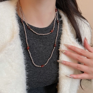 Close-up of layered tiger eye beaded necklace on model in bohemian ethnic style