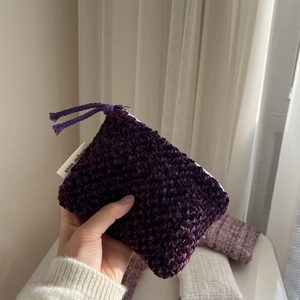 Detail view of purple woven tweed coin purse showing zipper closure and textured knit fabric