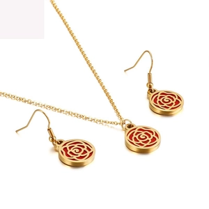 Elegant gold and red rose jewelry set with hollow flower necklace and earrings on white