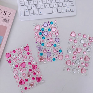 Detailed view of 3 sheets of colorful heart and teardrop 3D crystal rhinestone stickers