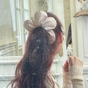 Elegant large satin flower scrunchie in dusty pink with silk texture on model