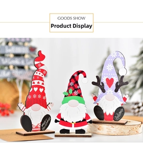 Three festive wooden Christmas gnomes on stands featuring red, green, and purple designs