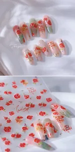 Detailed view of 3D rose nail stickers with elegant red floral patterns and gold accents