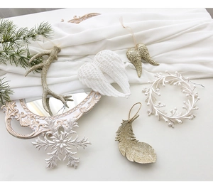 Exquisite white and champagne gold Christmas ornaments with glitter on satin background