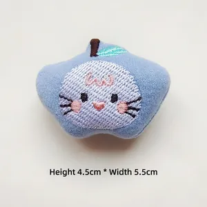 Blue plush apple-shaped patch with cat face embroidery and dimensions 4.5x5.5 cm