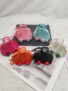 Mini car-shaped shell bags in 6 colors with lychee texture on a fashion magazine