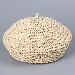 Detail of cream handmade crochet beret showing intricate hollow weave texture and top detail