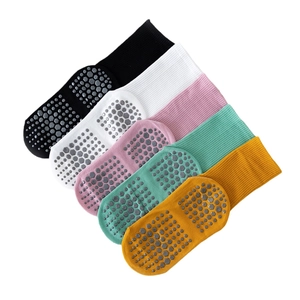 Set of five colorful non-slip yoga socks in black white pink green and yellow with silica dots
