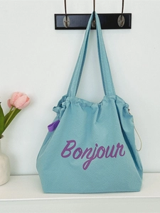 Light blue waffle fabric tote bag with purple Bonjour print and drawstring closure