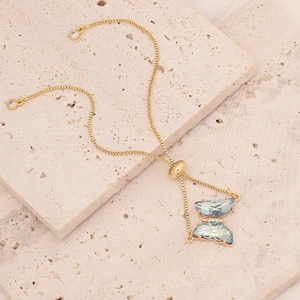 Detail view of 18K gold butterfly bracelet with light blue zircons and adjustable slider
