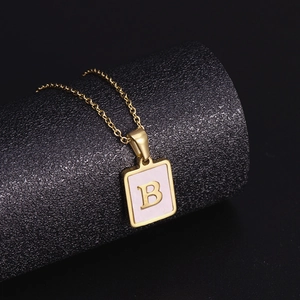 Detail of 18K gold stainless steel square necklace with letter B on shell inlay