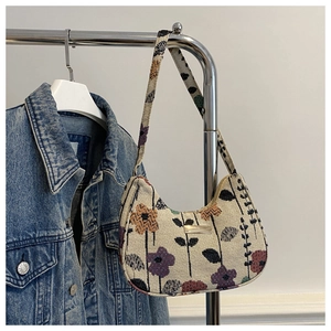 Close-up of beige corduroy underarm tote bag with colorful strawberry floral pattern