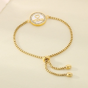 Macro shot of gold-plated bracelet with Mother pendant and sparkling zircon stones