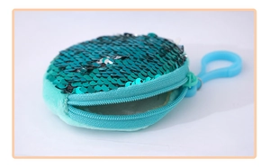 Detail of round sequin coin purse in teal blue with zipper and plastic carabiner clip