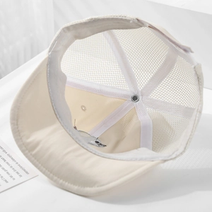 Detail of baby sun hat showing breathable mesh structure and neat inner stitching