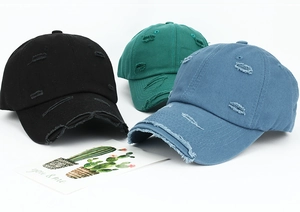 Distressed cotton baseball caps with torn details in black, dark green, and grey-blue