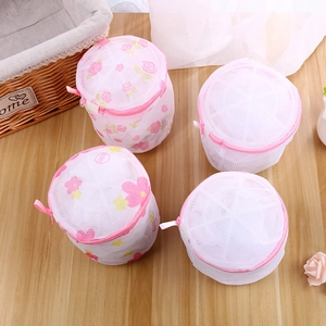 Set of 4 cylindrical mesh laundry bags for bras with pink floral and white designs