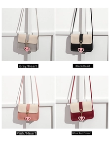 Detail view of four two-tone crossbody bags in grey, black, pink and burgundy colors