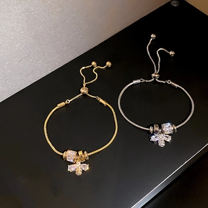 Adjustable bee charm bracelet set in gold and silver finish with zircon inlay